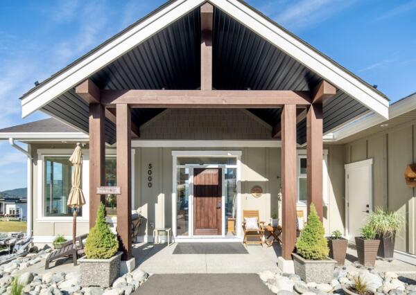 Large covered front entrance at custom home in Maple Bay