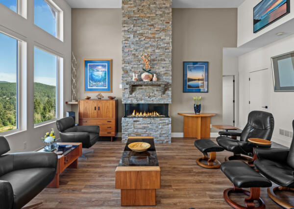 Living room with rock fireplace and tall ceilings