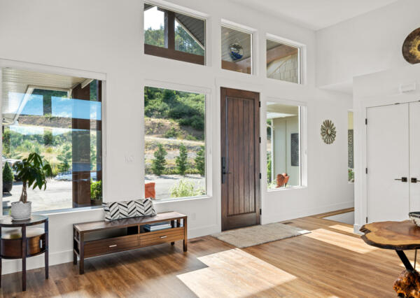 Front entrance with large dark wood door and large windows