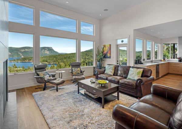 Great room that is open concept with large windows and ocean views