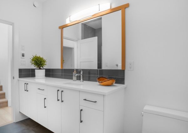 Powder room bathroom with white cabinetry and countertops