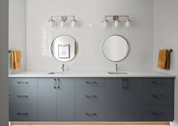 Double blue vanity with lots of storage and white subway tile