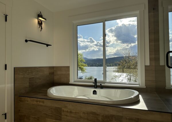 Drop in bath tub in primary bathroom with lake views