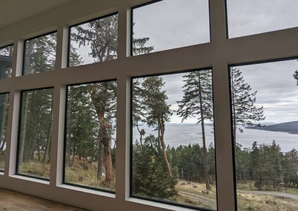 Wall of windows with ocean views in custom home