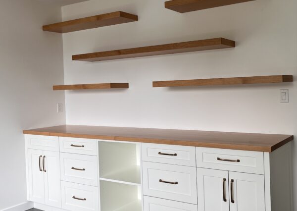 Built in cabinetry in office with floating shelves