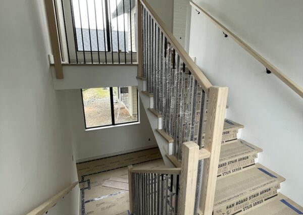 Wood staircase with tall ceilings and natural light