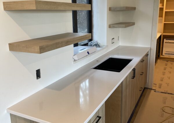 Wood cabinetry with white countertops in custom home