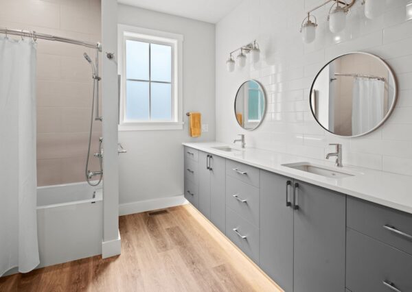 Children's bathroom with double grey vanity and wood floors