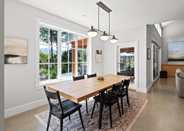 Dining room with modern chandelier and large windows