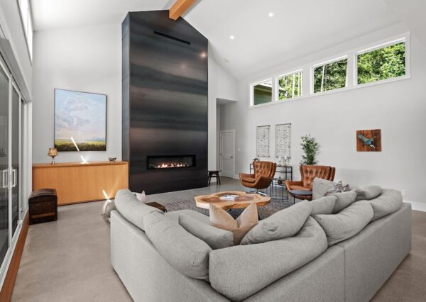 Large family room with tall ceilings, natural light and large fireplace