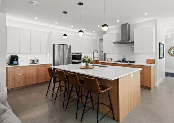 Custom designed kitchen with black pendant lights and large kitchen island