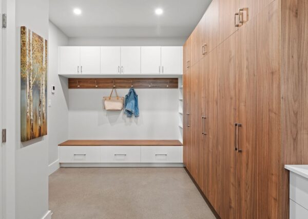 Mudroom with built in storage and concrete flooring