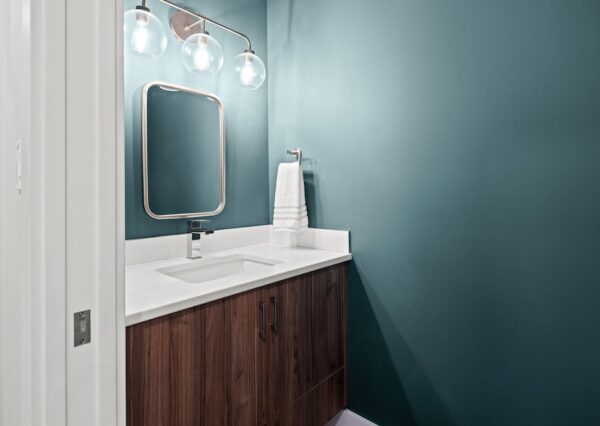 Green bathroom with dark wood vanity